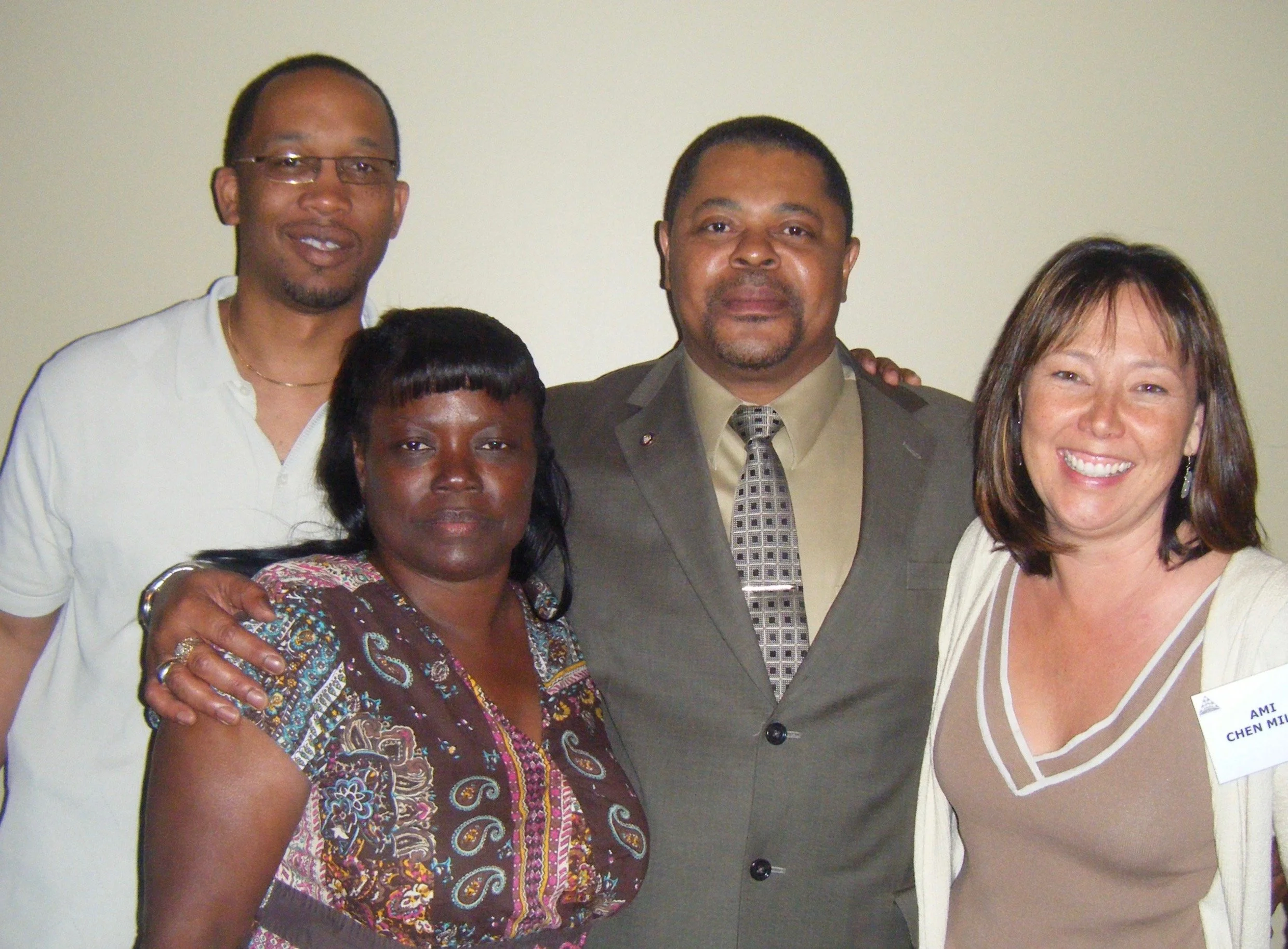 Two African American men and  one African American woman with candidate, Asian American woman with mid-length hair, smiling. Portrait.