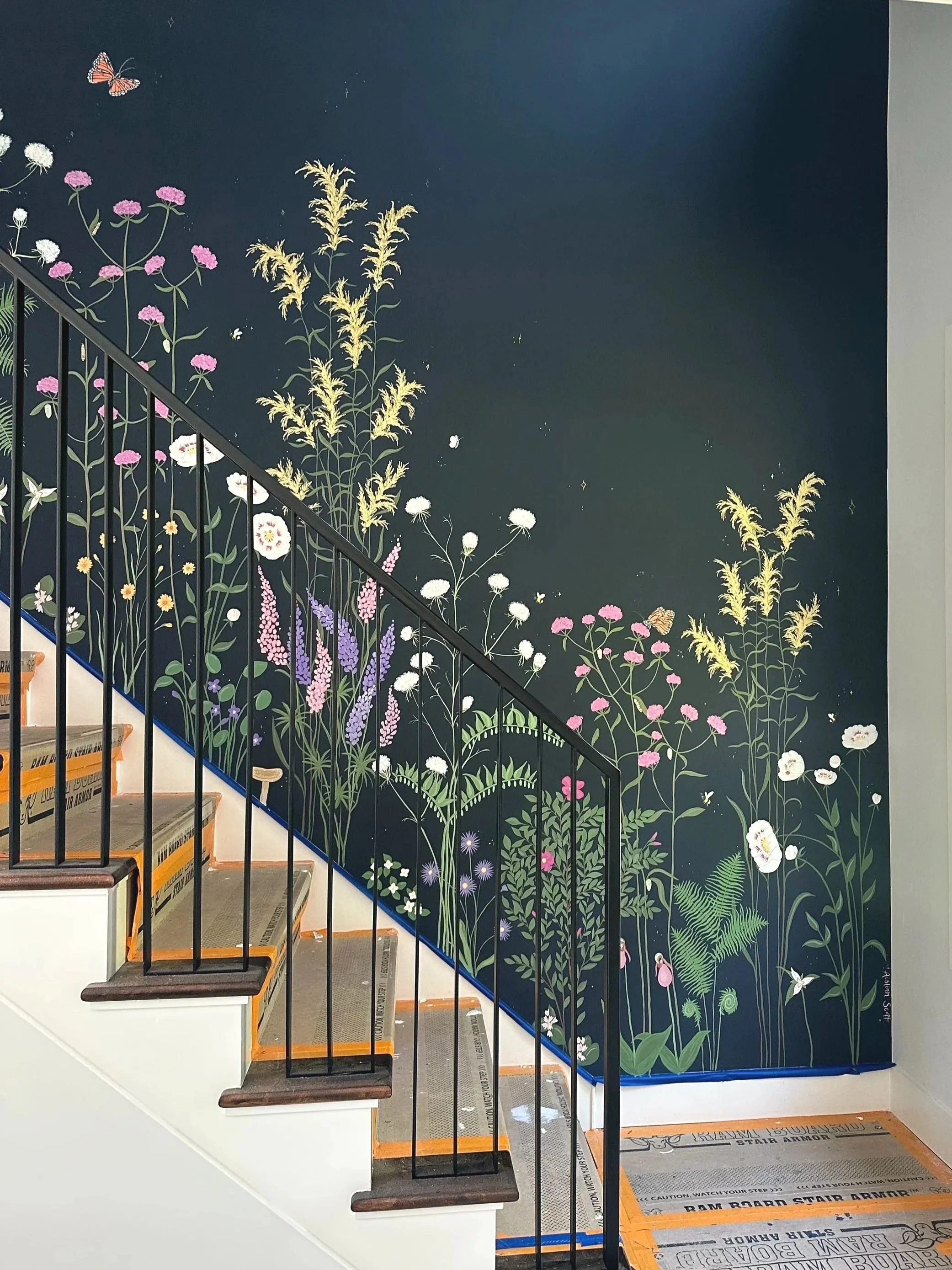 Navy Blue wall of a stairwell painted with Florals.