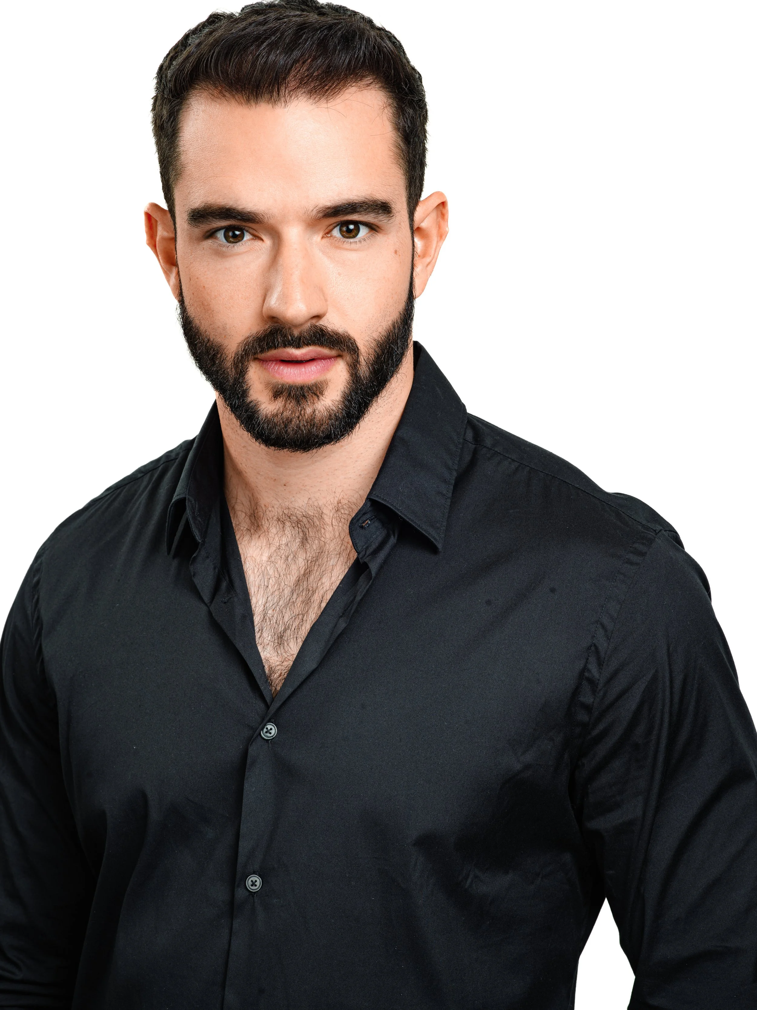 Close-up of a man with short dark hair and a beard, wearing a black collared shirt, against a white background.