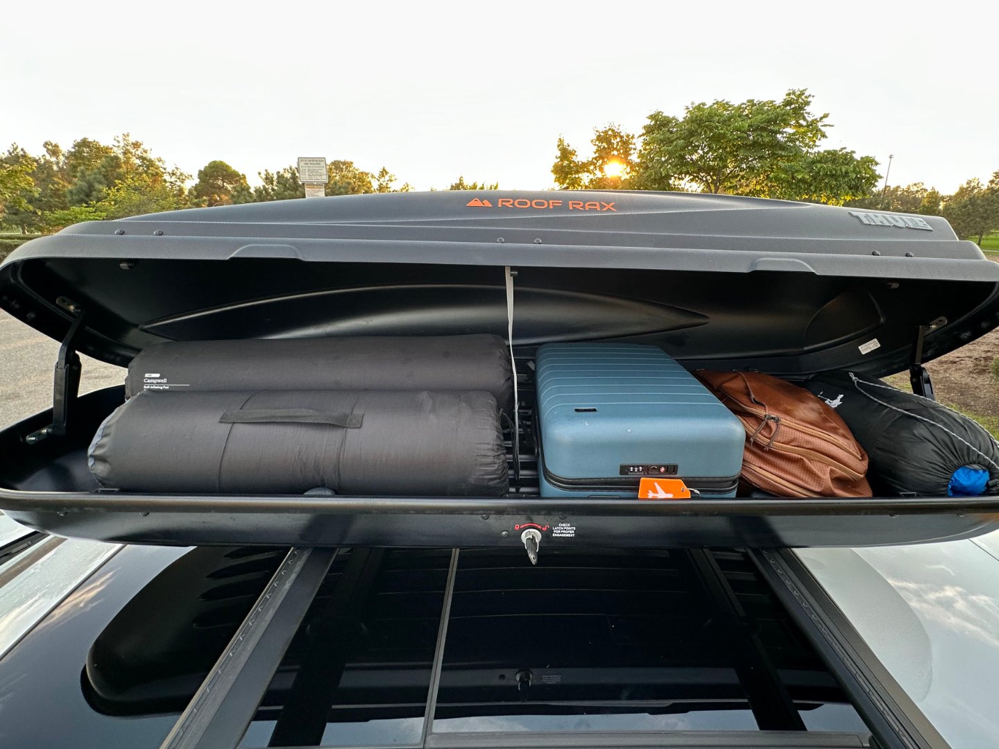 Thule cargo box packed with luggage for a road trip