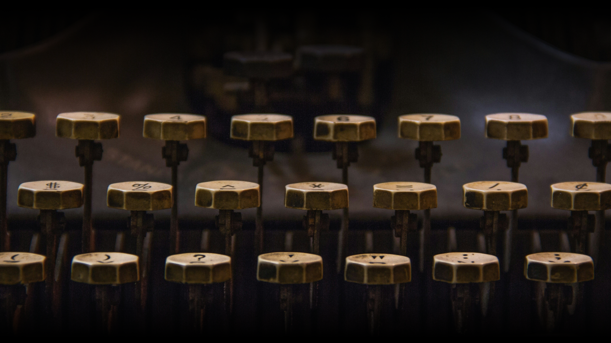 Close-up of vintage typewriter keys with symbols and numbers, background out of focus.