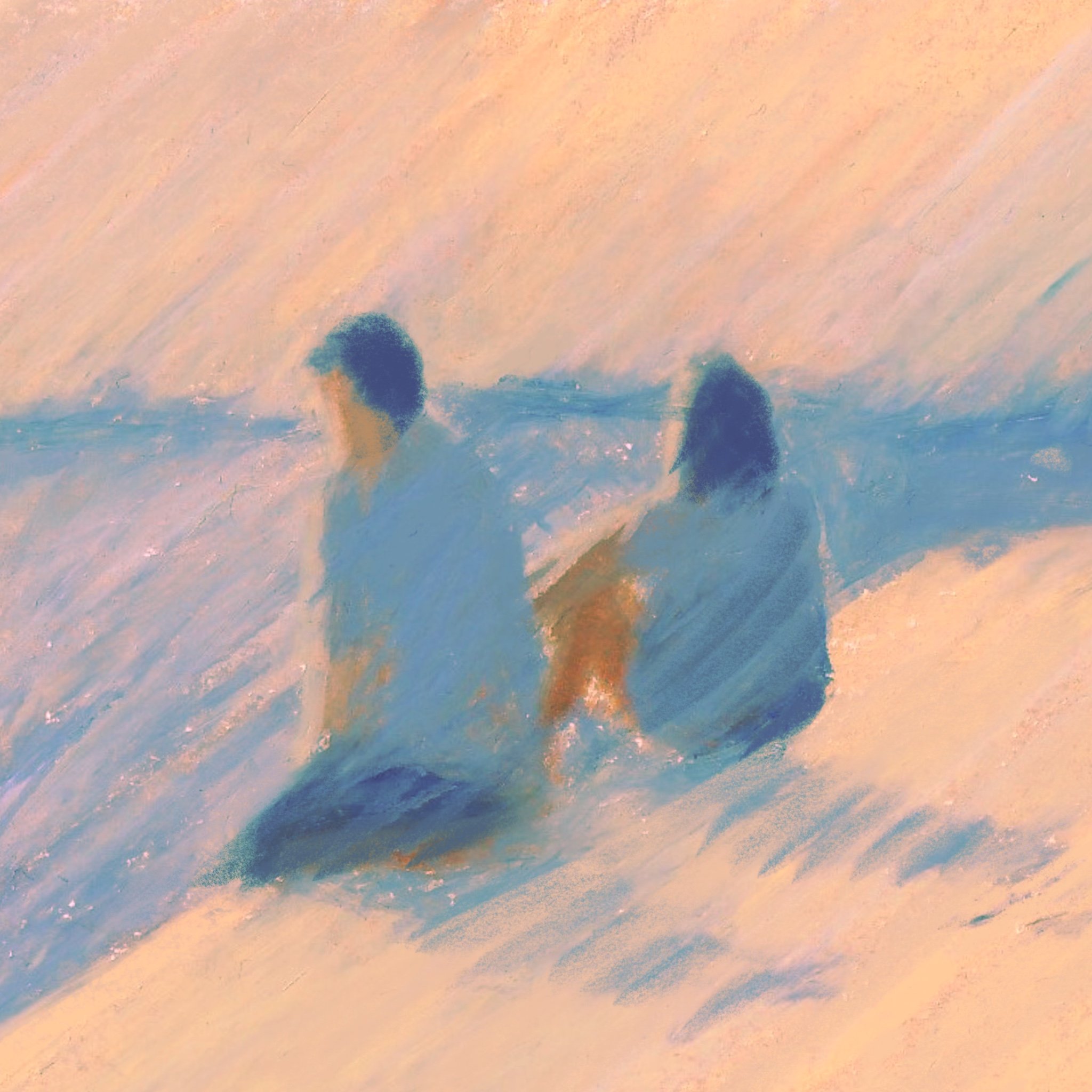 Two people sitting on the sand at the beach, facing the water, with the waves approaching.