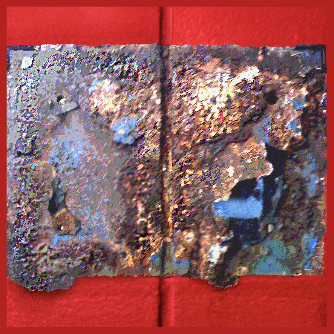 Close-up of an open, textured book with colorful, rough pages, laying on a red surface.