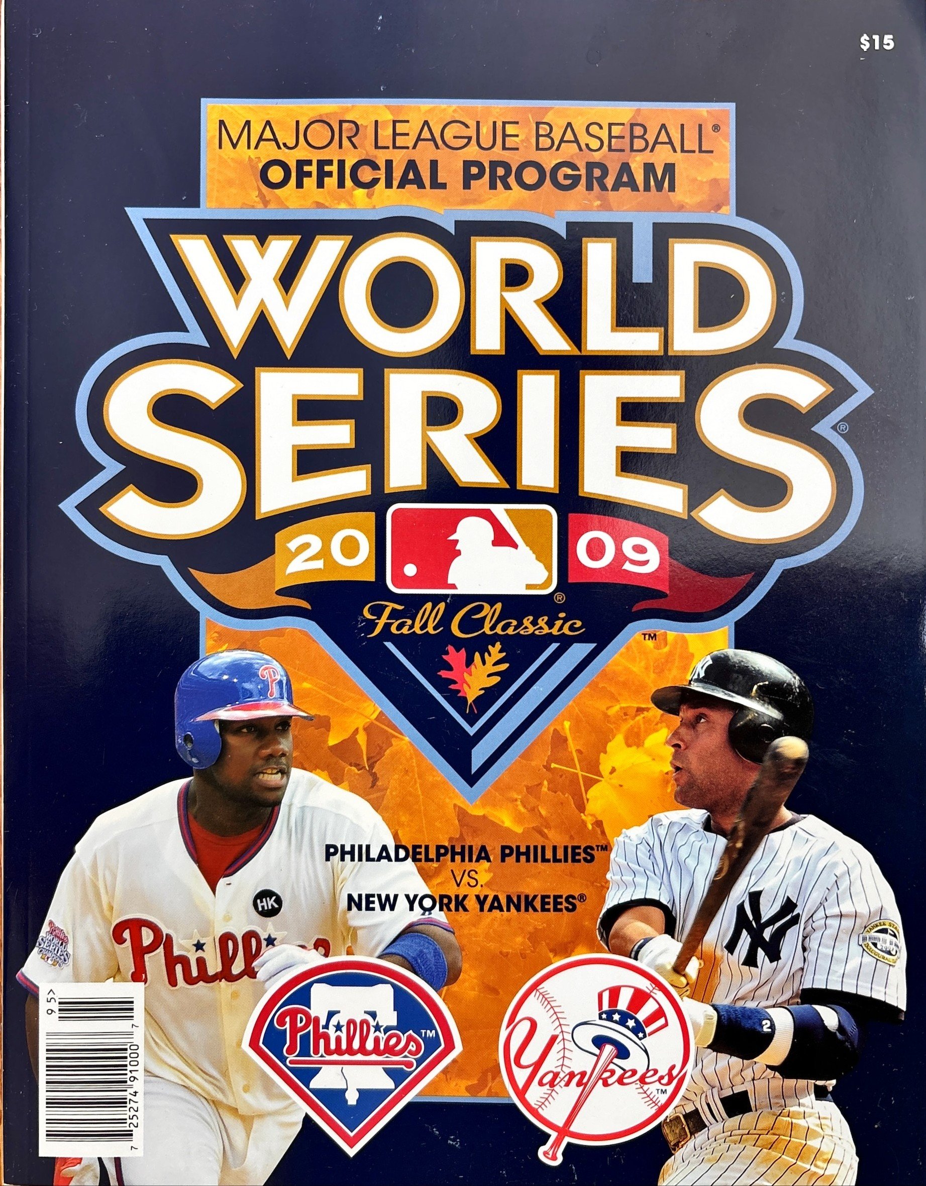 The cover of the 2009 Major League Baseball World Series official program featuring players from the Philadelphia Phillies and the New York Yankees, with Phillies and Yankees logos and an autumn leaf background.