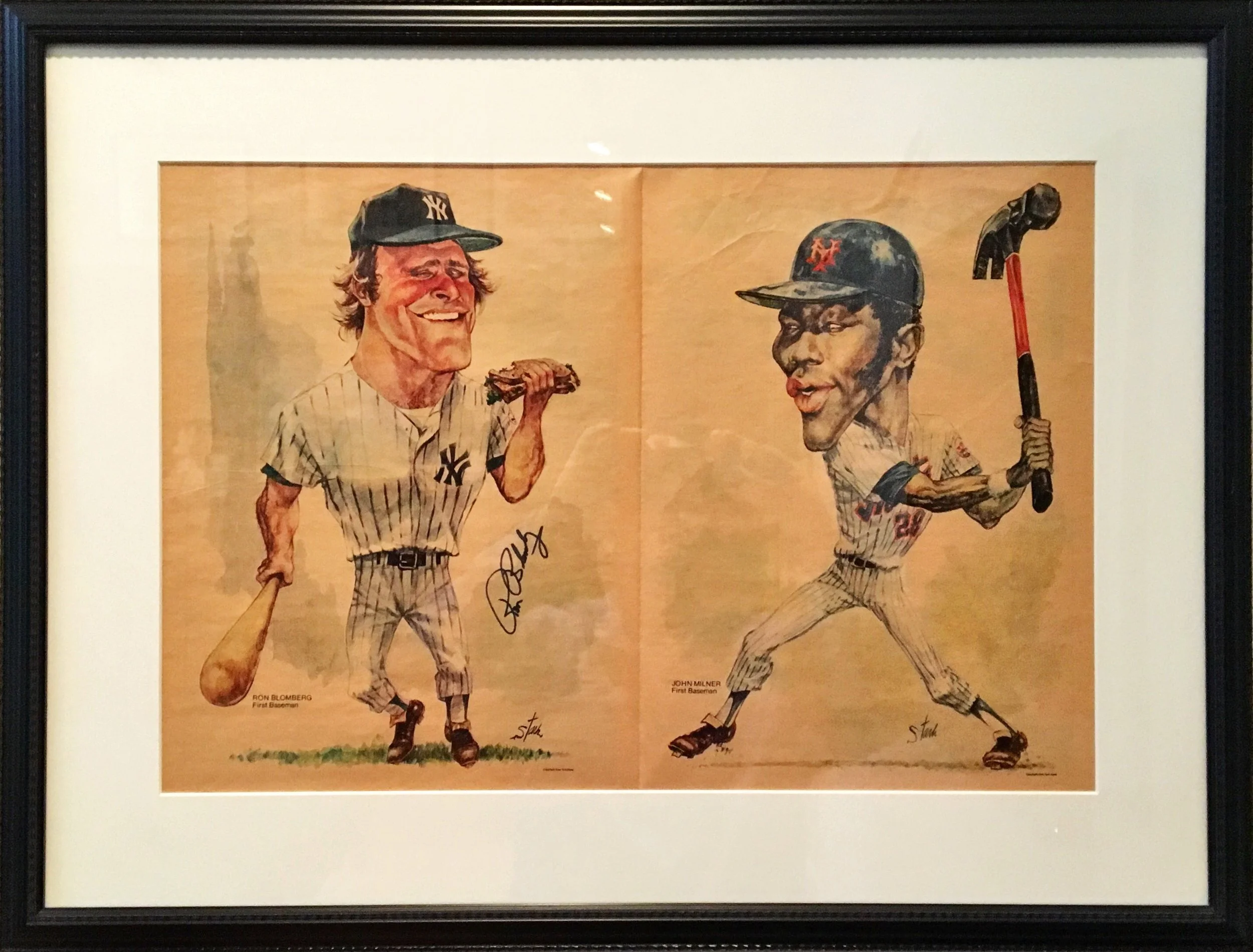 Framed illustration of two baseball players from the New York Yankees. The player on the left, Ron Bloomberg, is depicted holding a sandwich and wearing a Yankees uniform with a cap. The player on the right, John Milner, is shown in a batting pose, holding a bat, also in a Yankees uniform and cap. The background is plain with signatures at the bottom.