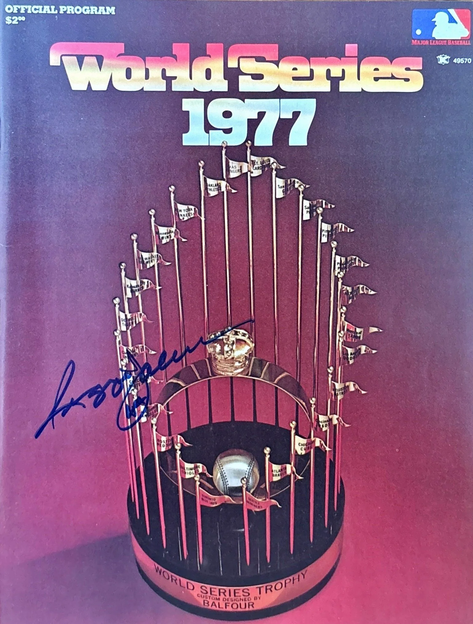 1977 World Series trophy with small baseball flags representing participating teams from that year, set against a red background.