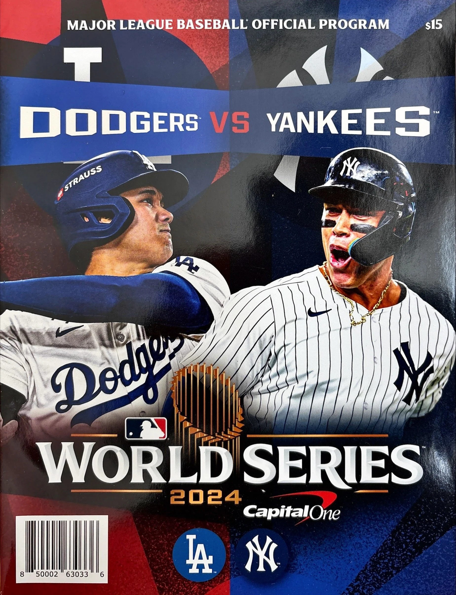 Major League Baseball World Series 2024 program cover featuring a split image of two baseball players, one from the Dodgers and one from the Yankees, with a blue banner displaying 'Dodgers vs Yankees'. Logos of both teams are shown, along with the MLB logo and the sponsor Capital One.