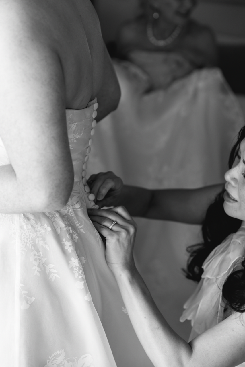 Thuy Nguyen Couture helping the bride with her wedding dress.
