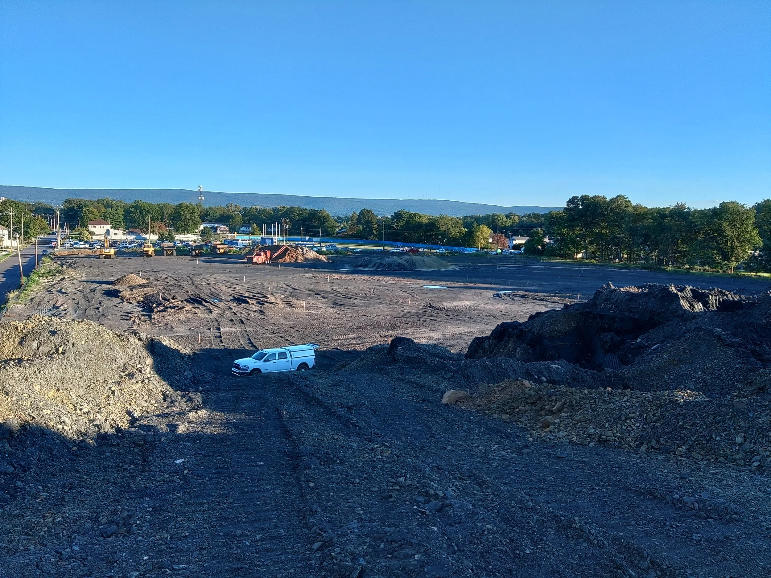 Marked construction site showing survey stakes for layout and boundary work.