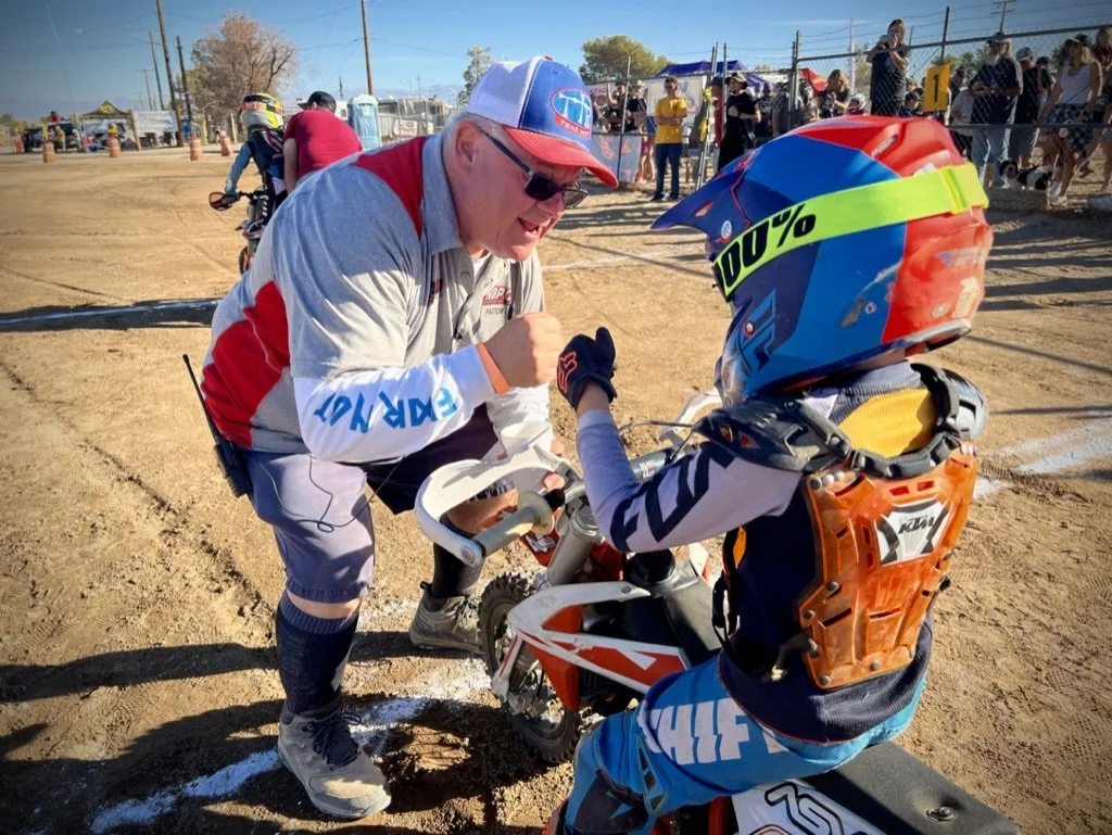Jay Young of Team True Ministries praying over a young dirt bike rider racing the NGPC in district 37 d37.  Racing, family, protecting and praying.