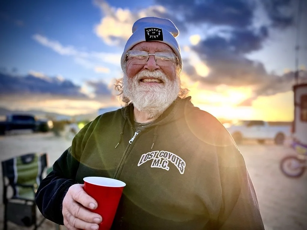 A 'Lost Coyote M.C.' member at the first Checkers MC race of d37 hare and hound.  His racing days are over but it's about protecting the next generation and giving back at motocross races.