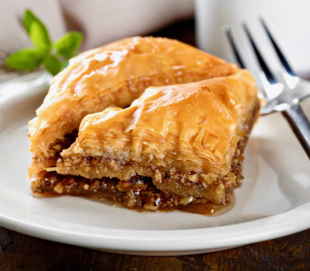 Baklava - Layers of flaky phyllo pastry filled with sugared & spiced walnuts, soaked in a citrus-infused honey syrup.