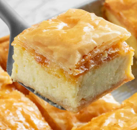 Galaktoboureko — Flaky layers of phyllo pastry filled with creamy semolina custard and finished with a sweet citrus-infused syrup.