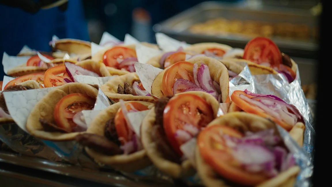 Gyro - Warm toasted pita filled with seasoned gyro meat, fresh tomato and onion, finished with creamy tzatziki sauce.