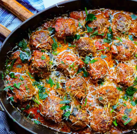 Keftethes - Savory meatballs seasoned with traditional Greek herbs and spices, baked and served with a rich tomato sauce.
