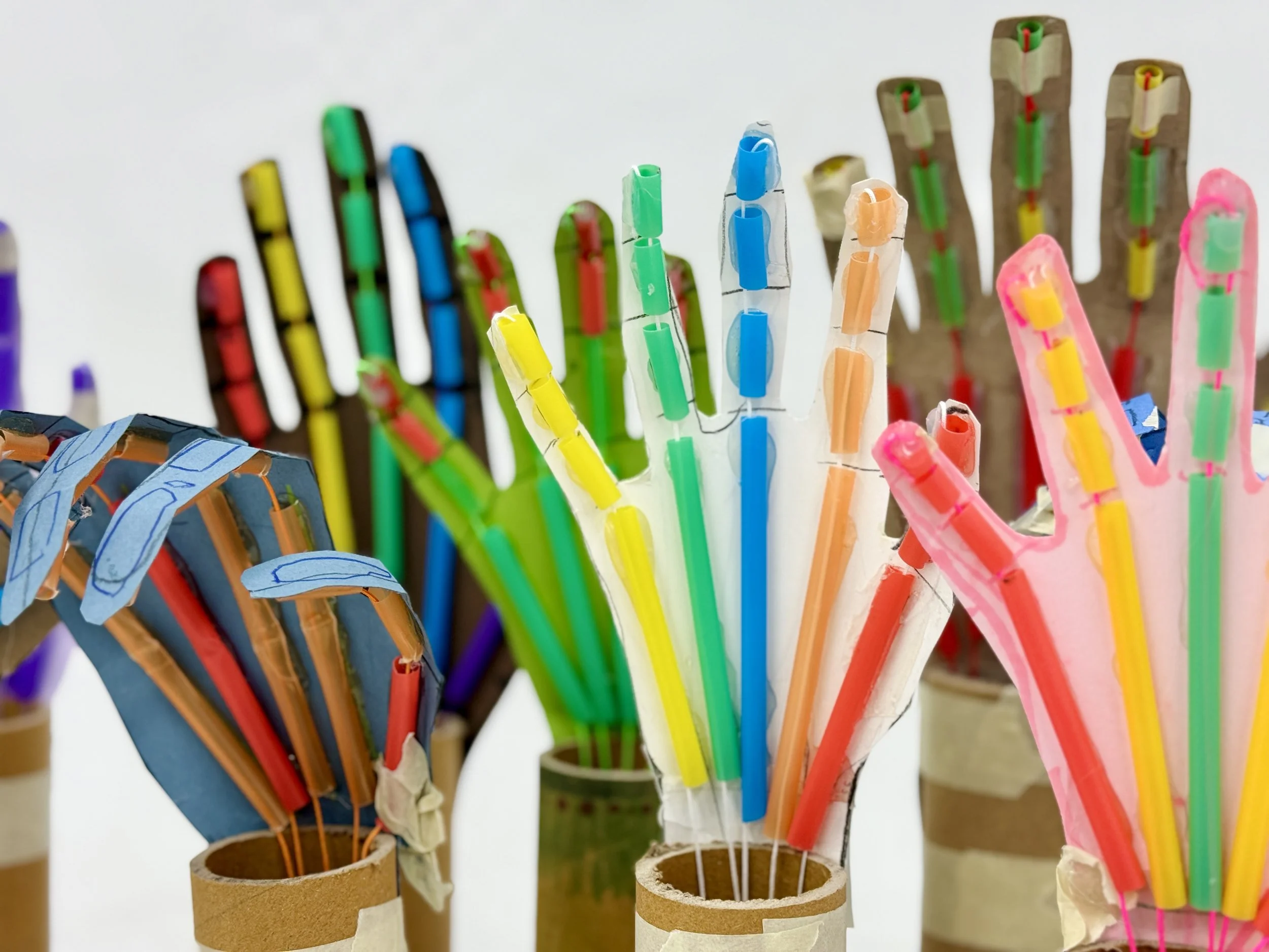 Colorful homemade fireworks in cardboard tubes with paper and plastic decorations.