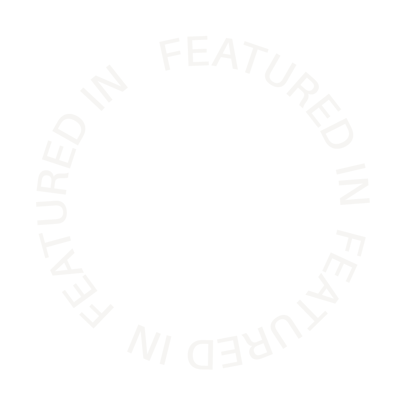 Decorative element on page: Circular text in white reading "FEATURING IN FEAUTRED IN FEATURED IN"