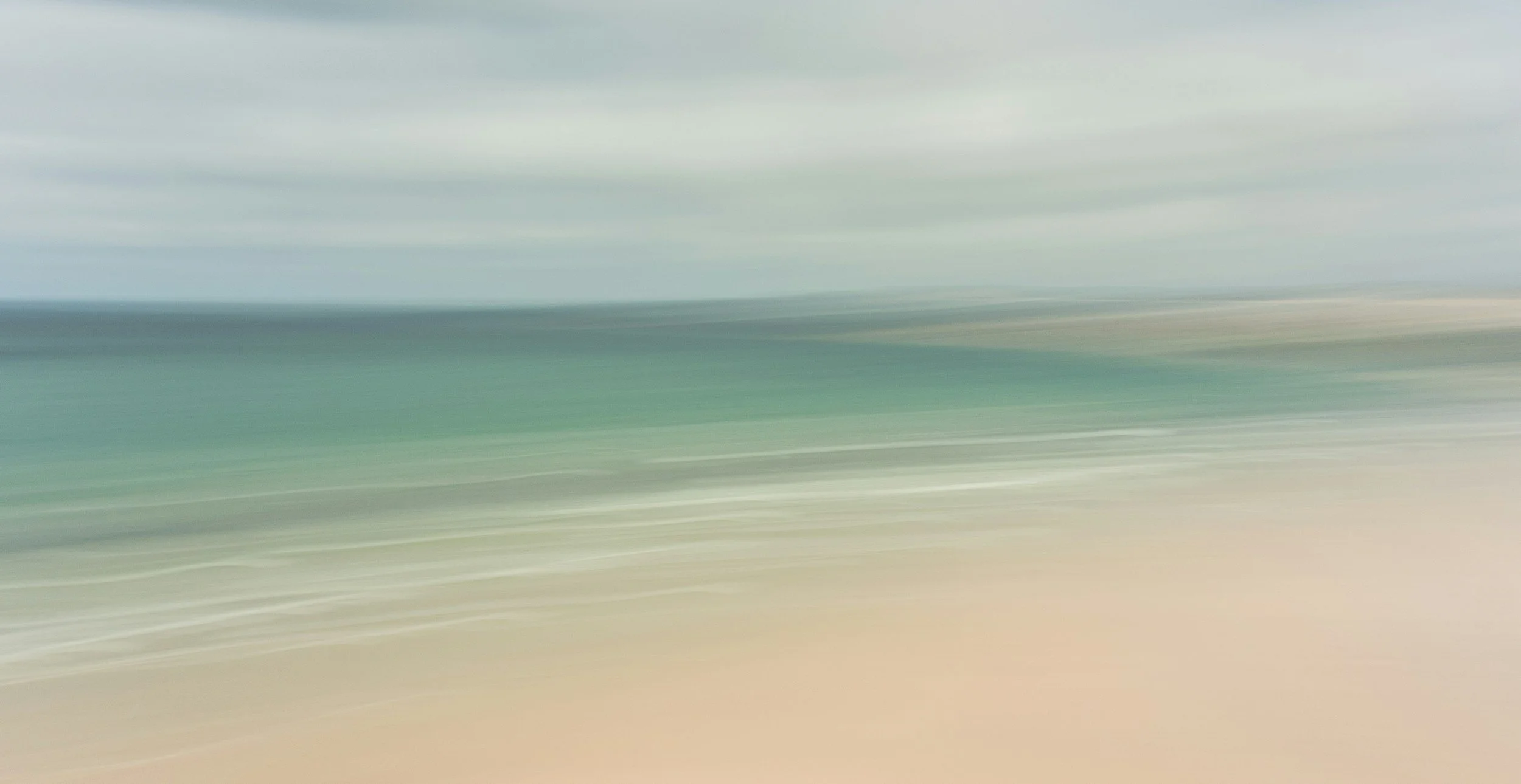 Abstract blurred image with horizontal streaks in shades of gray, blue, beige, and white, resembling motion blur or a long exposure shot.
