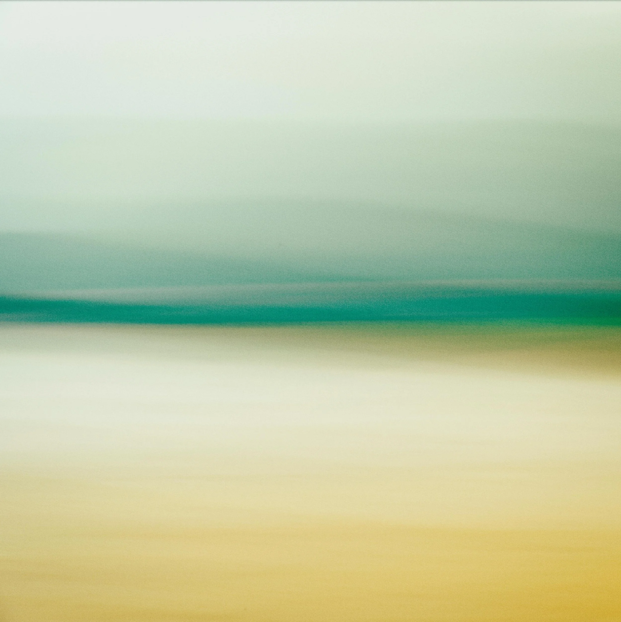 A blurred gradient background with shades of light green, yellow, and beige.