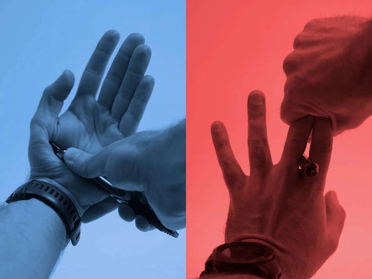 A diptych showing a plastic pen being pressed against a hand. On the left, the pen is pressed into the palm of the under blue light. On the right, the pen is held between two fingers that are then crushed together with another hand under red light.