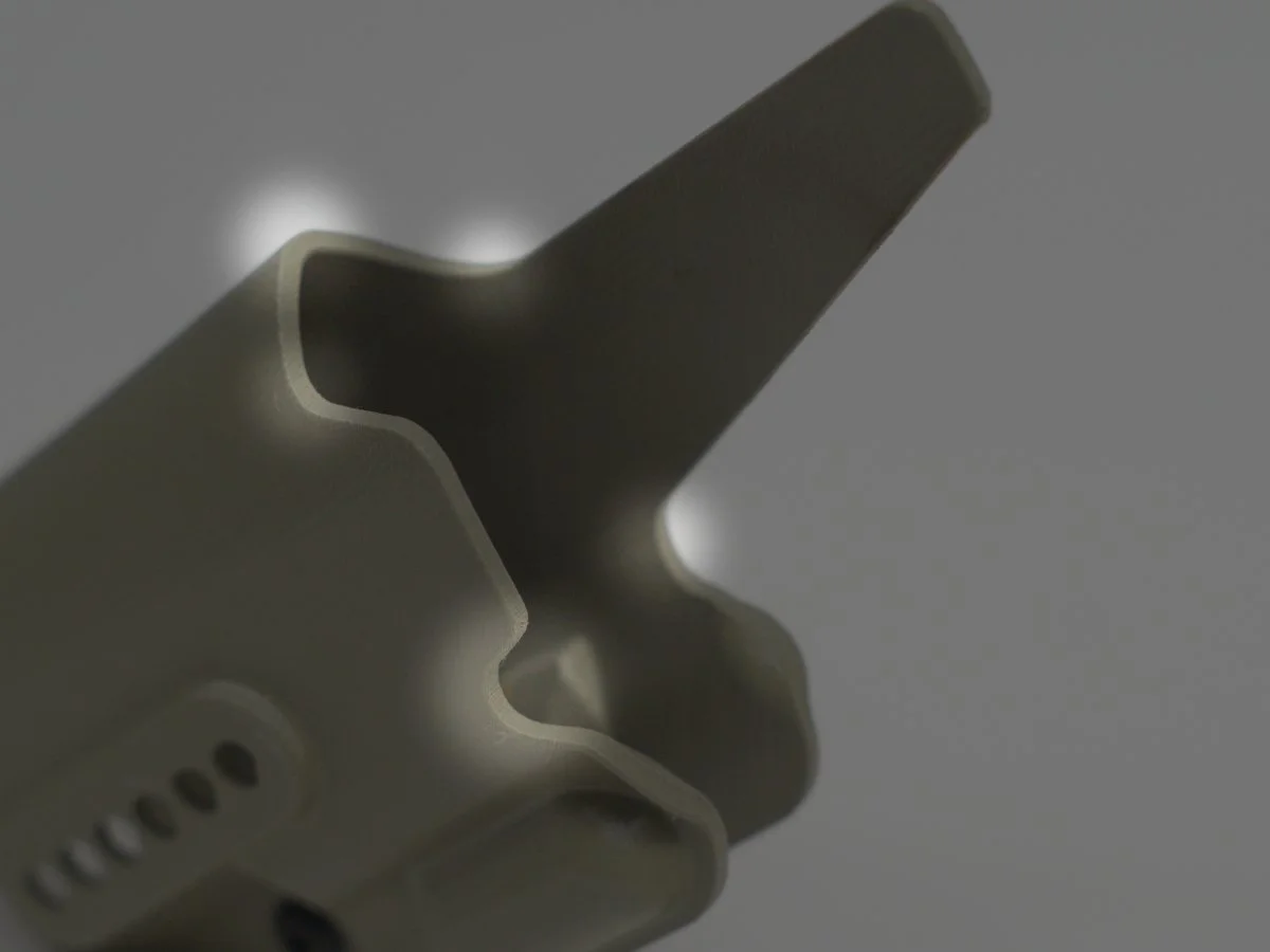 Close-up of the top of a Mockingbird Holsters holster, with spotlights indicating potential high stress points that should be routinely inspected.
