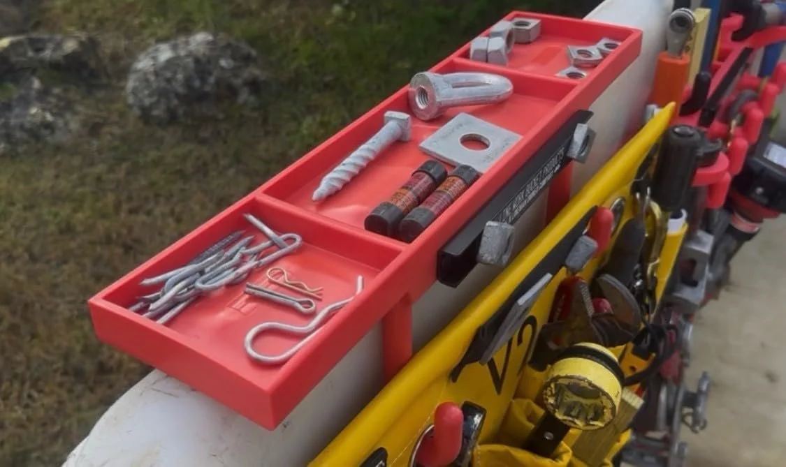 Flat rack tray for bucket trucks providing a clean workspace for hardware, connectors, and small parts during aerial line work.