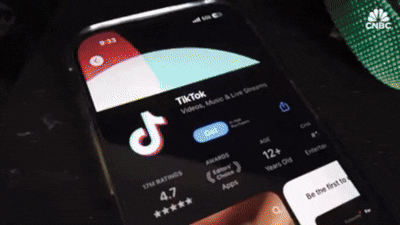 Smartphone displaying TikTok app with app ratings and download button