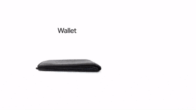A closed black wallet placed on a white surface with the word 'Wallet' above it displaying Google Wallet in use.