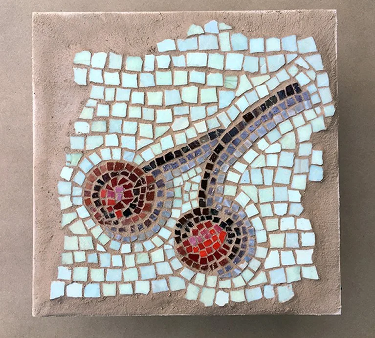 Mosaic artwork of two sperm cells on a beige tiled background.