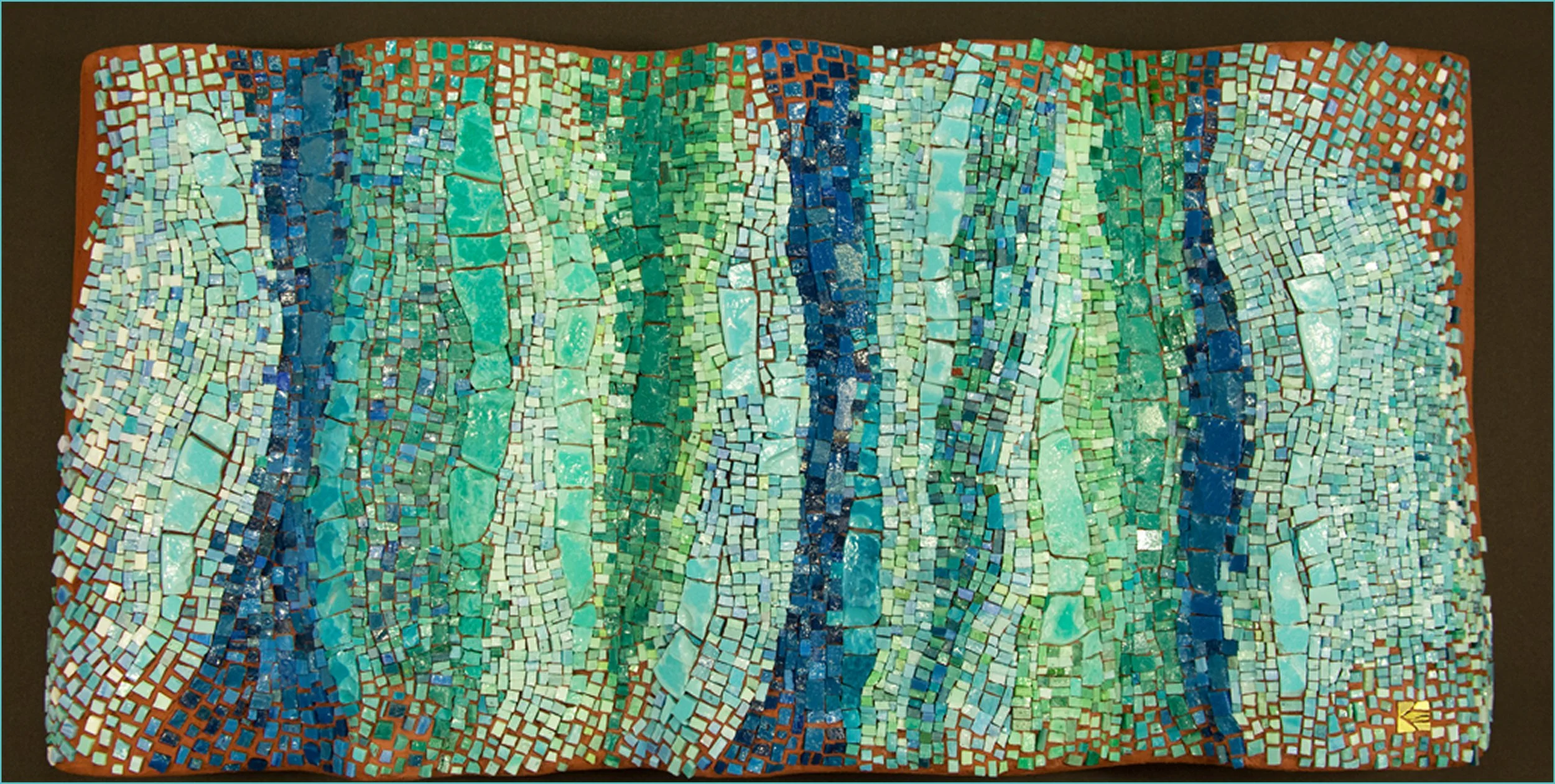 Colorful mosaic artwork with small square tiles in shades of blue, green, and white arranged in flowing, wavy patterns.