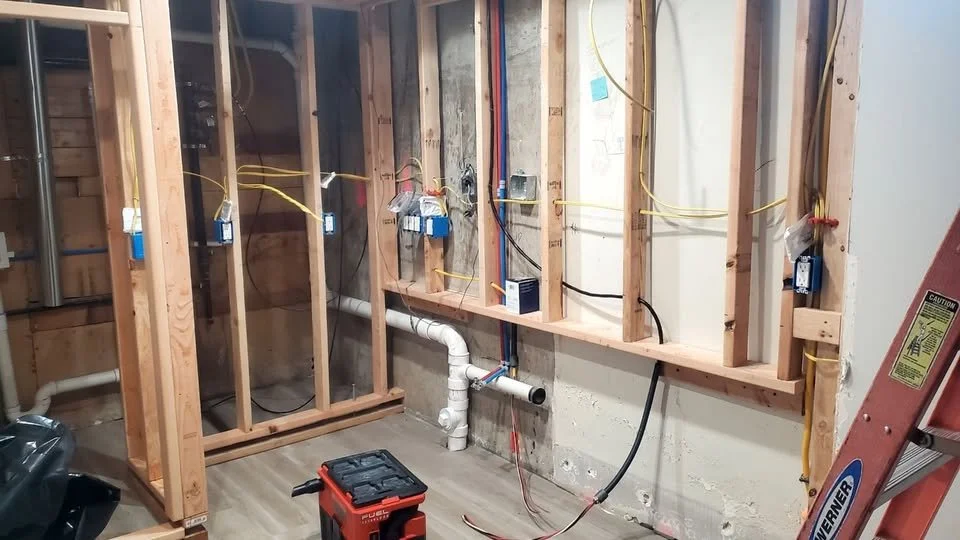 Basement kitchen wiring in Edgewater — Electrical installation for a basement kitchen in Edgewater. The rough-in photo shows wiring and outlet boxes within the open wall framing.