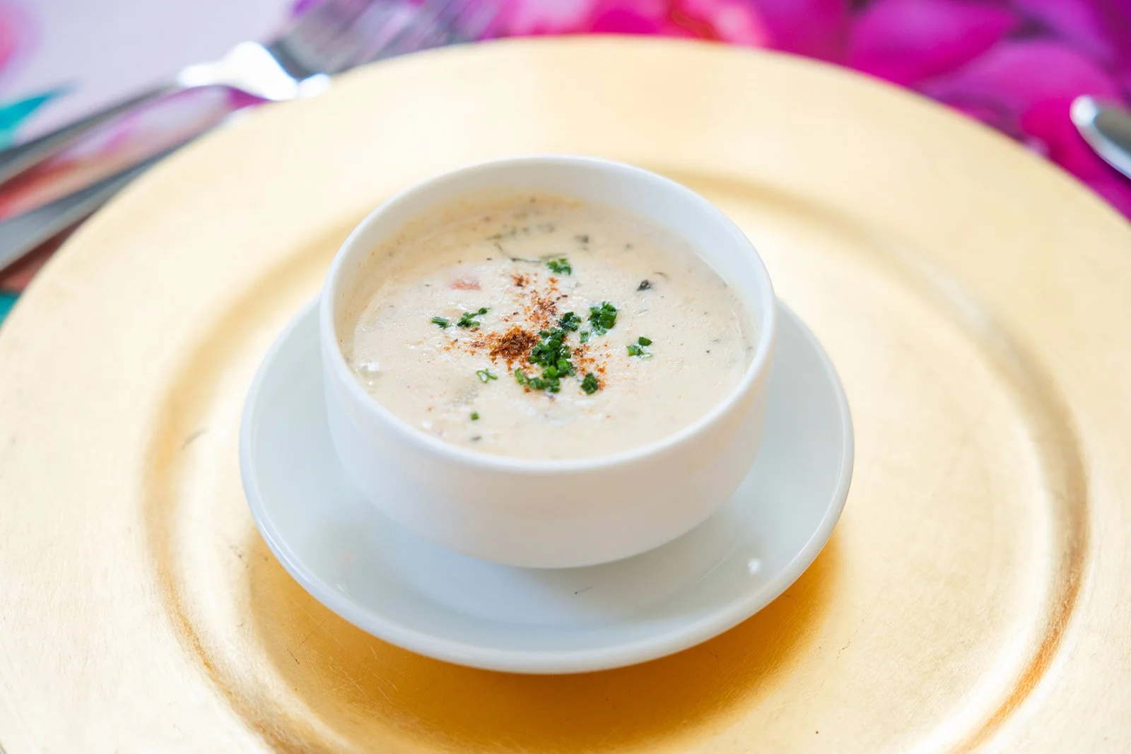 Elegantly plated cream soup course on gold charger plate served during catered event at Morrison House Old Town Alexandria