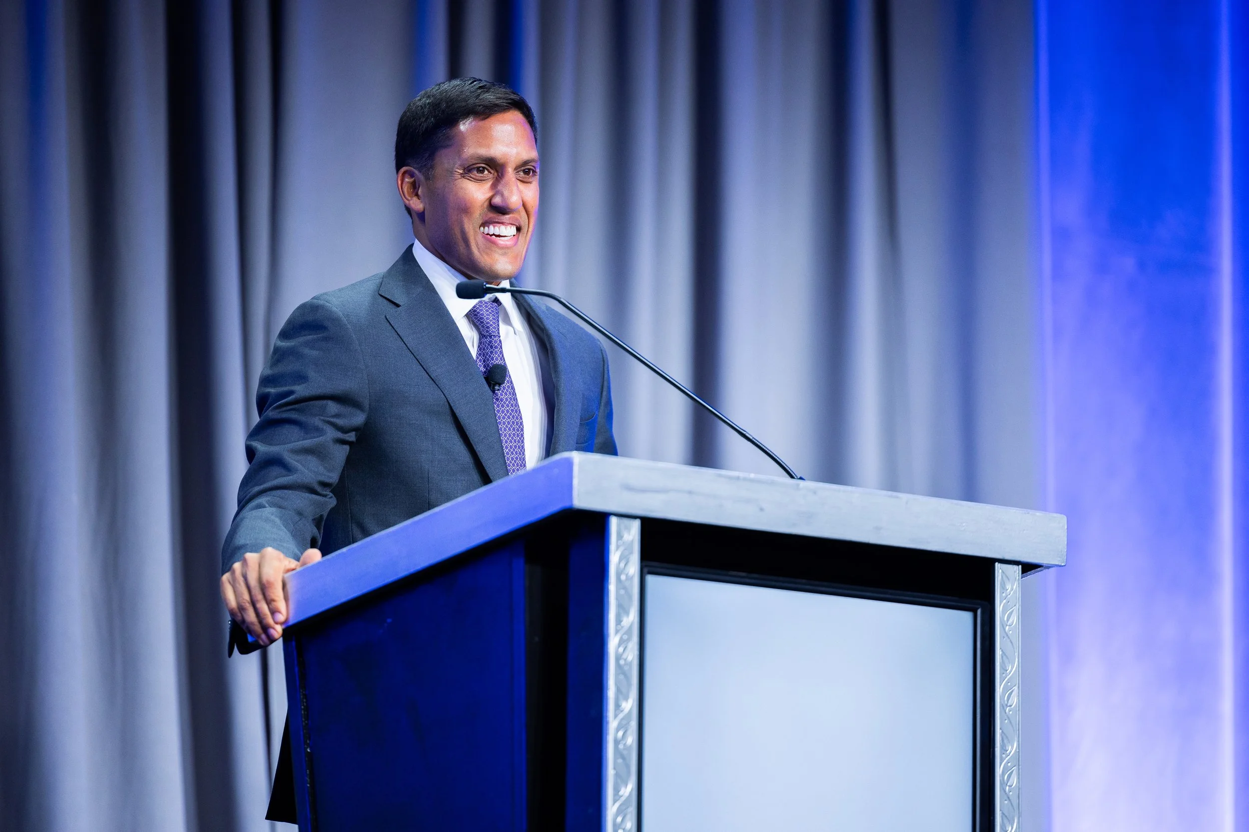 Keynote speaker presenting at corporate conference podium during professional event in Washington DC