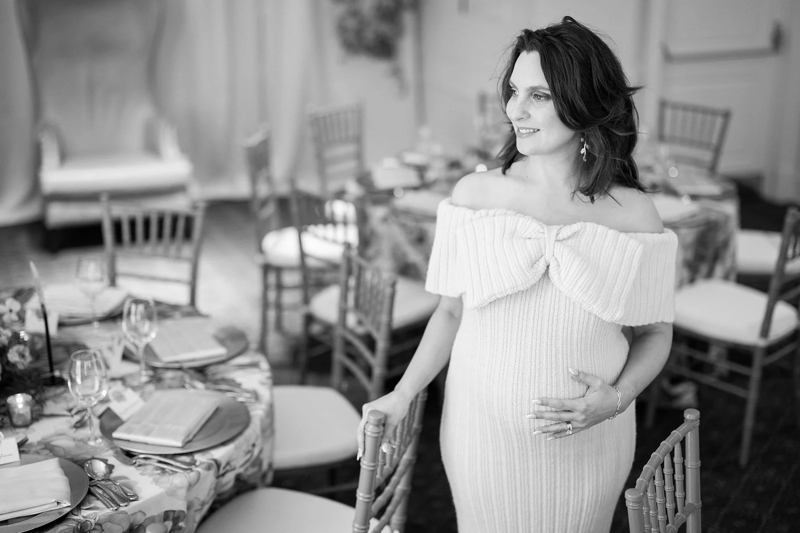Black and white portrait of expectant mother in Morrison House ballroom surrounded by chiavari chair event seating
