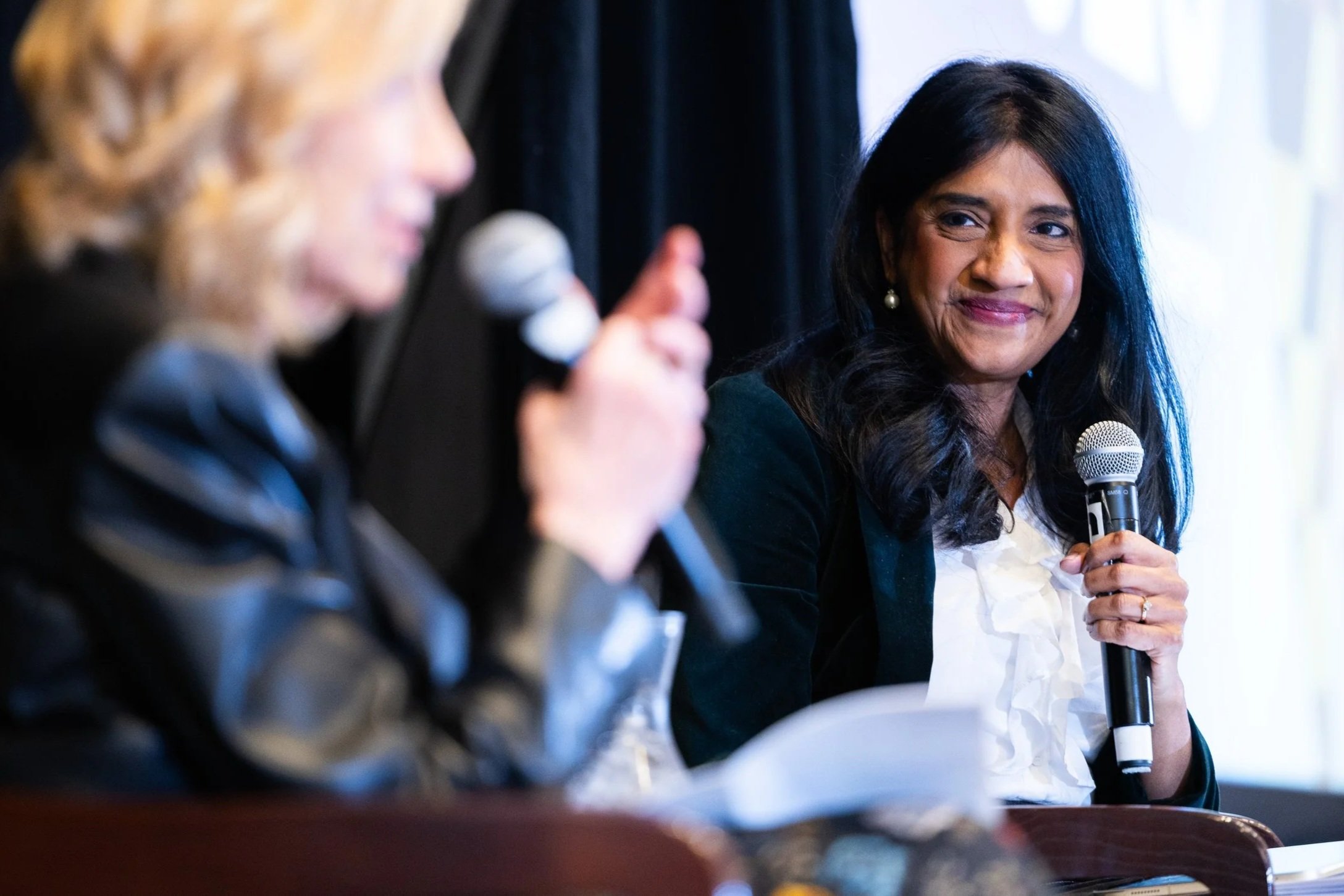Speaker participating in panel discussion during corporate conference event