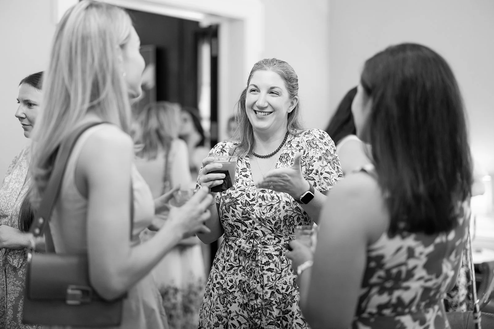 Black and white candid photograph of guests mingling during reception at Morrison House Old Town Alexandria