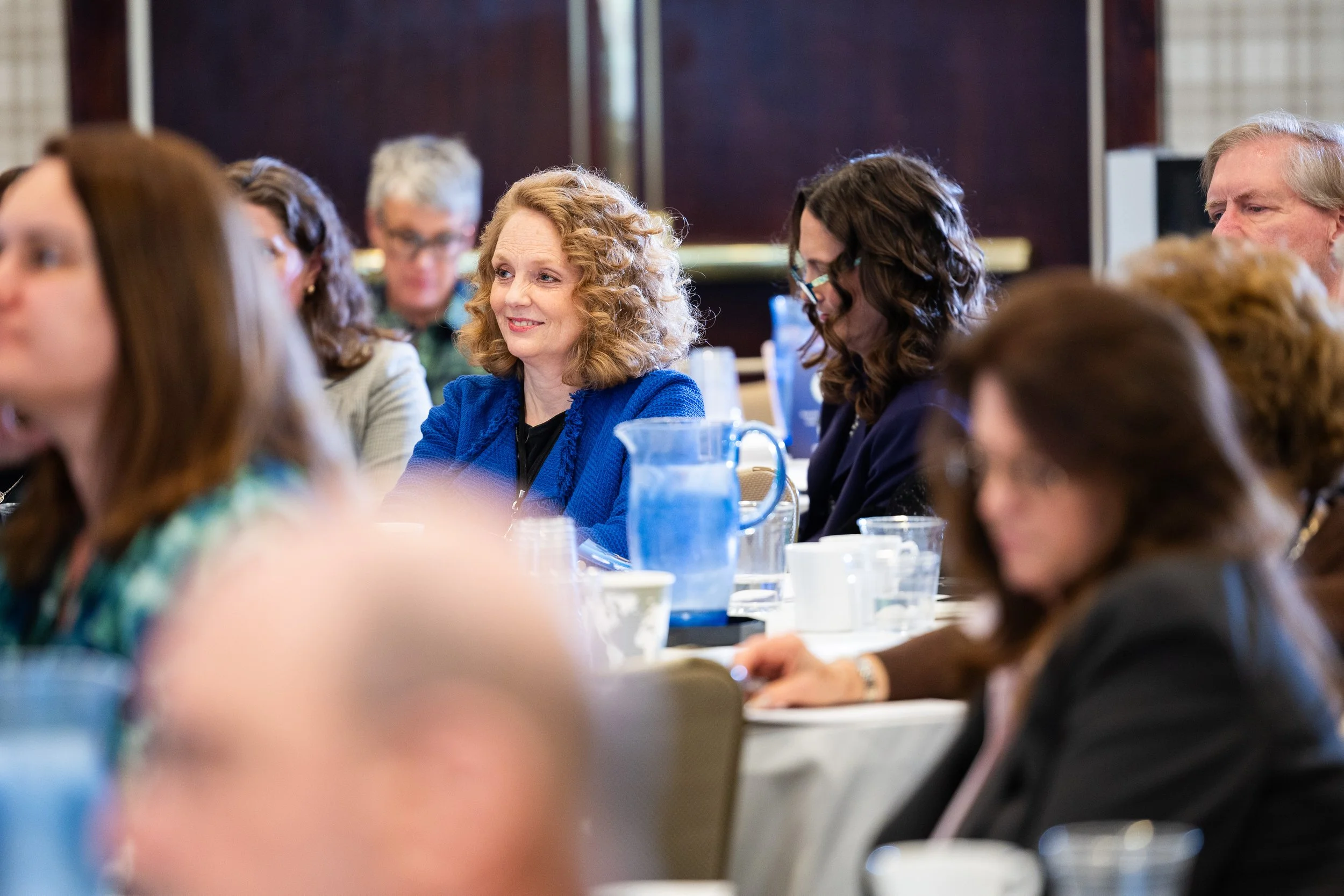 Corporate event attendees listening during a conference session in Washington DC with professional event photography coverage