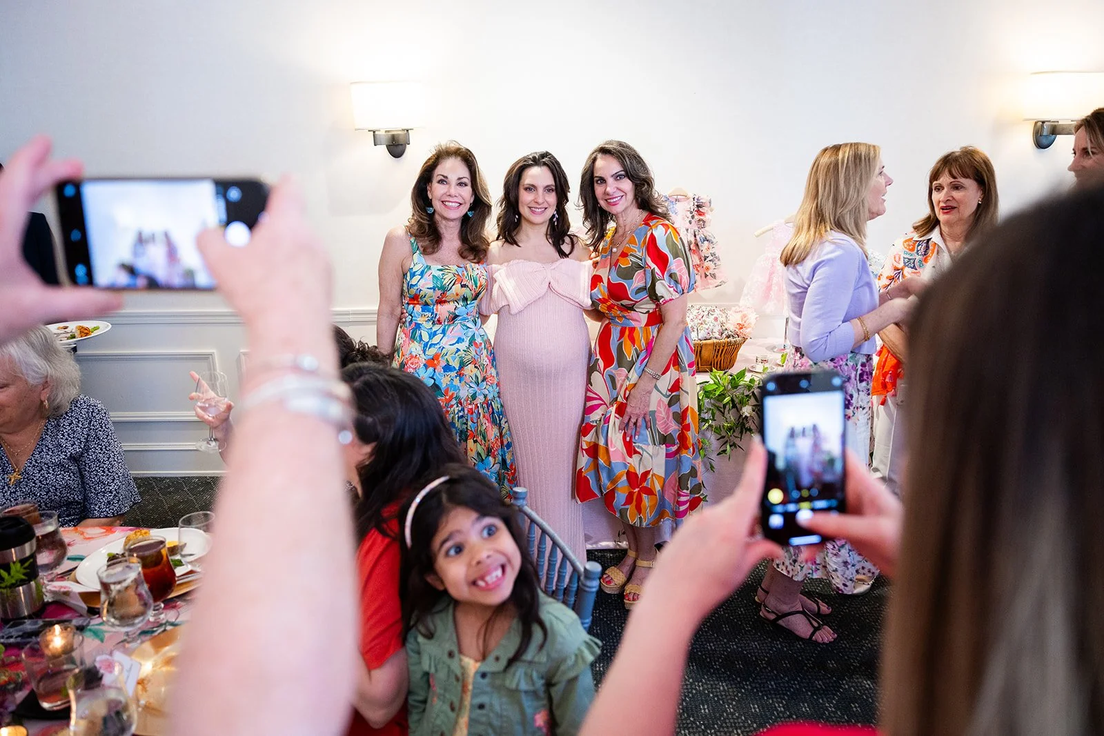 Candid moment of guests photographing the expectant mother during celebration at Morrison House Old Town Alexandria
