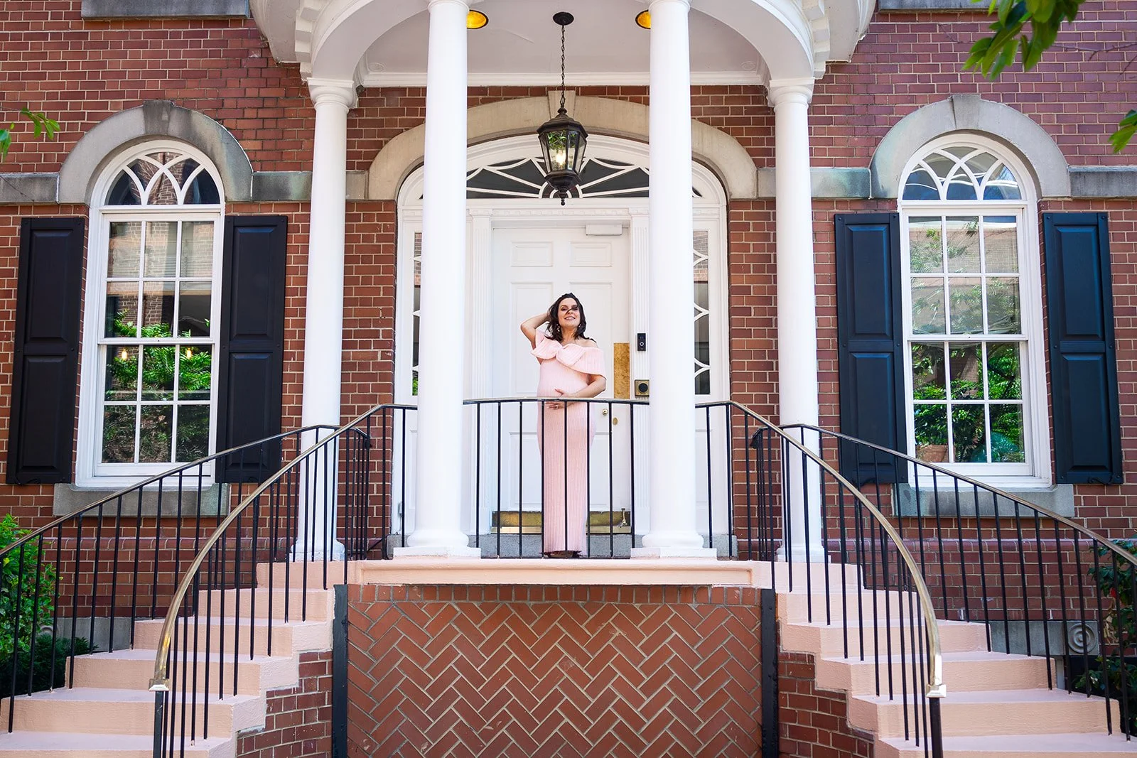 Expectant mother photographed on the front steps of Morrison House historic brick facade in Old Town Alexandria Virginia