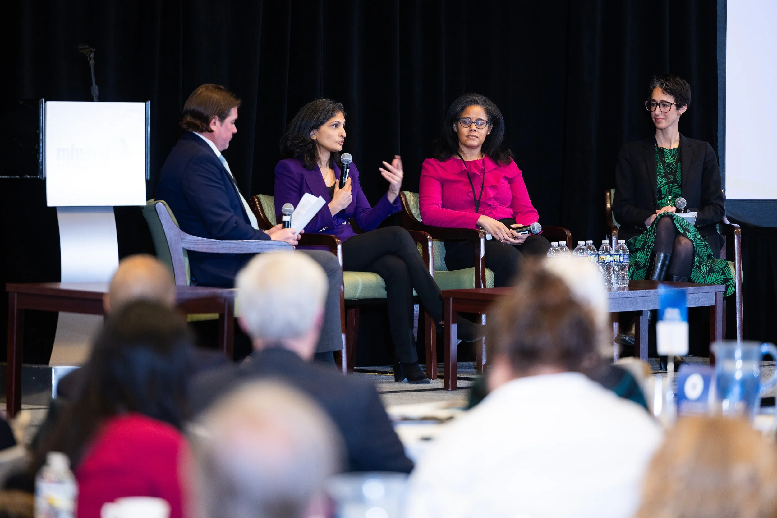 Panel discussion with speakers on stage at corporate conference in Washington DC