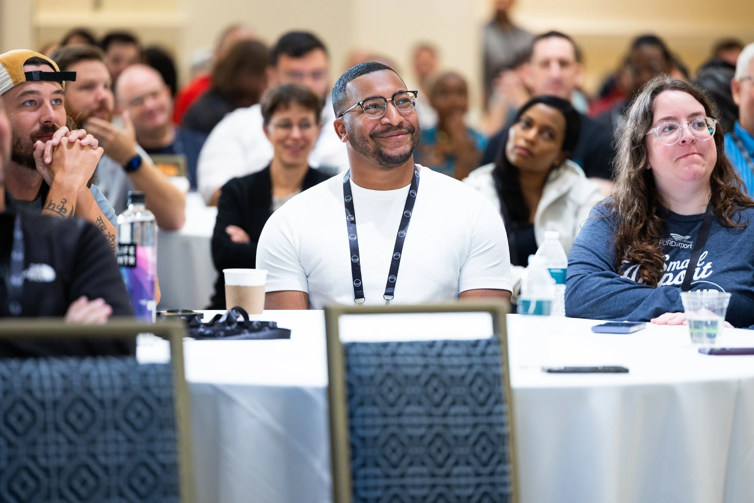 Attendee smiling at keynote speaker at a corporate event in Washington dc