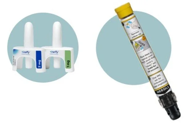 Two nasal spray devices side by side and a tube of nasal spray medicine.