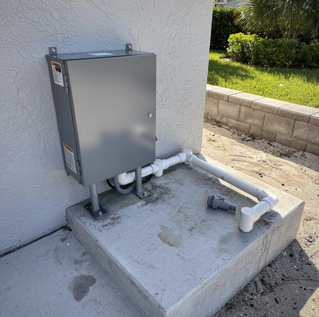 gray pool timer box mounted beside pump motor