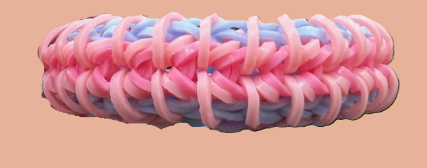 A coiled rubber band with pink, purple, and blue colors