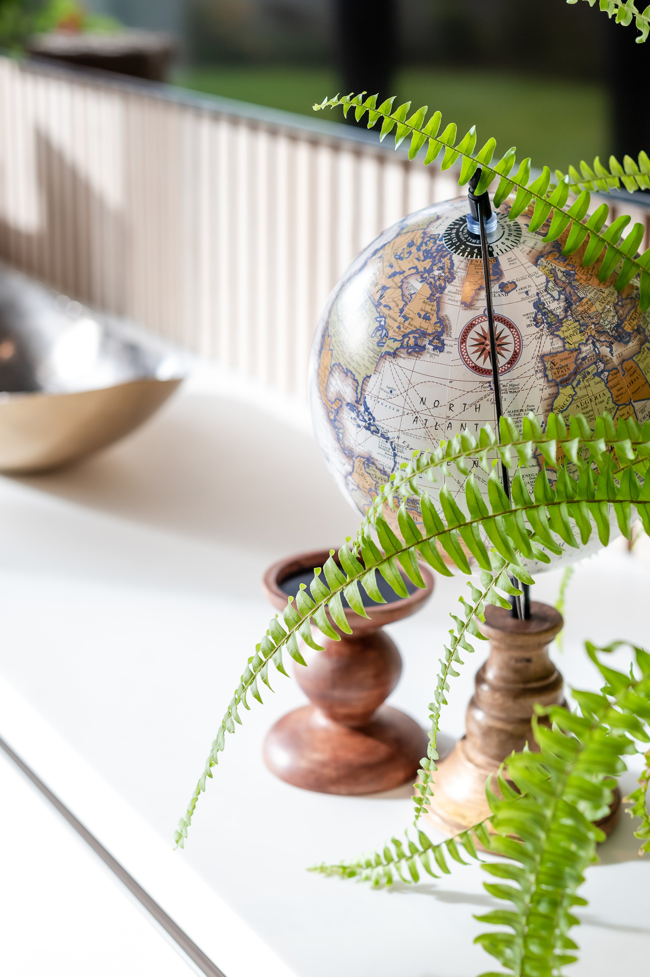 Styled interior detail of a charcoal console cabinet with botanical accessories, textured decor and modern organic styling in a Cheshire family home designed by Studio Dimora.