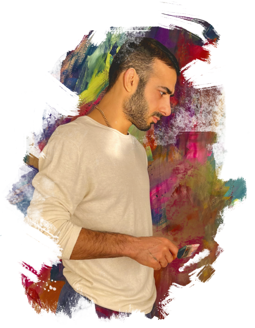 A young man with a beard and short dark hair, wearing a light-colored long-sleeve shirt and a gold chain, looking at his phone against a colorful, abstract painted background.