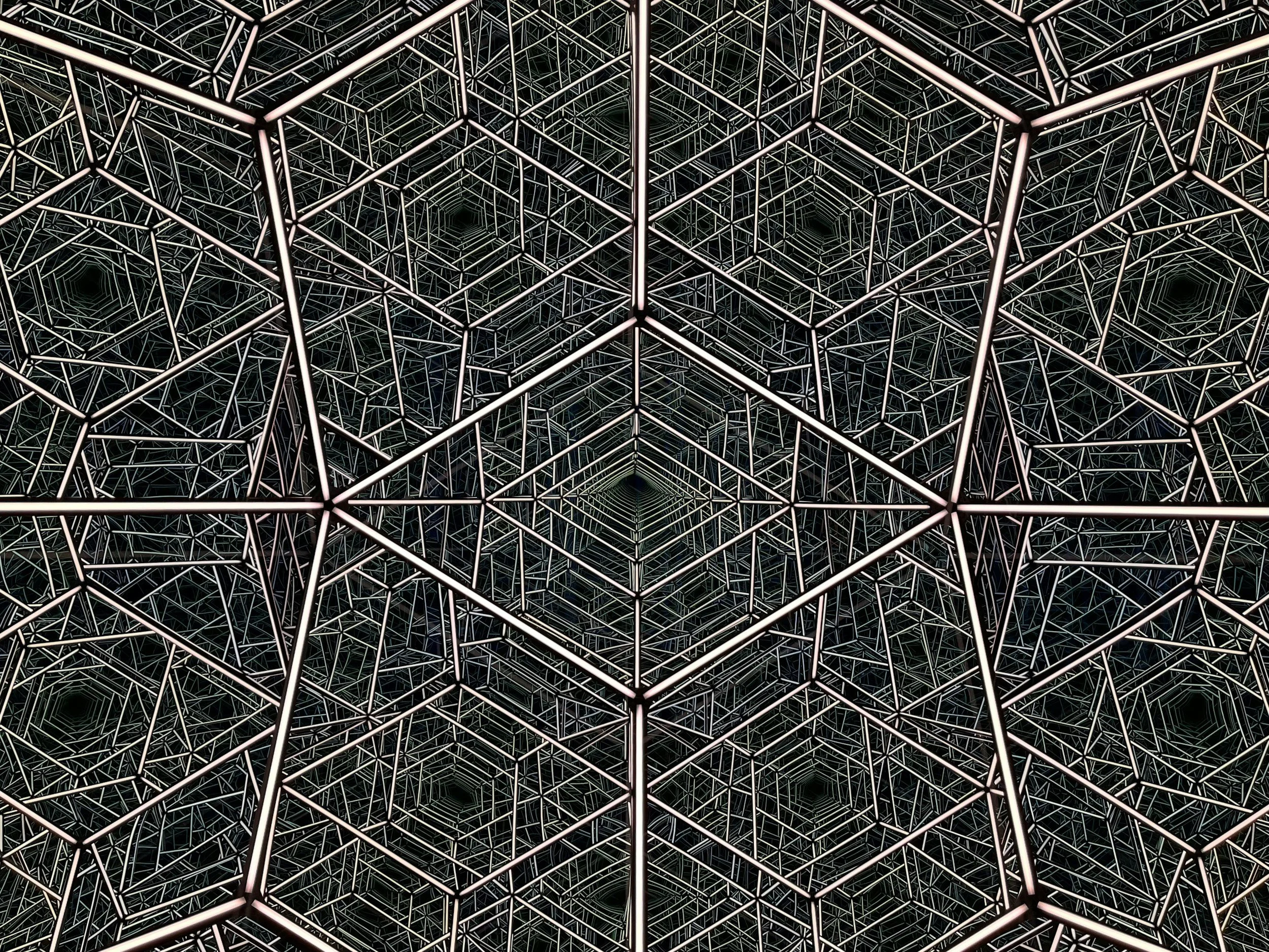 A geometric pattern of interconnected cubic frames with illuminated edges, creating a tunnel-like illusion.