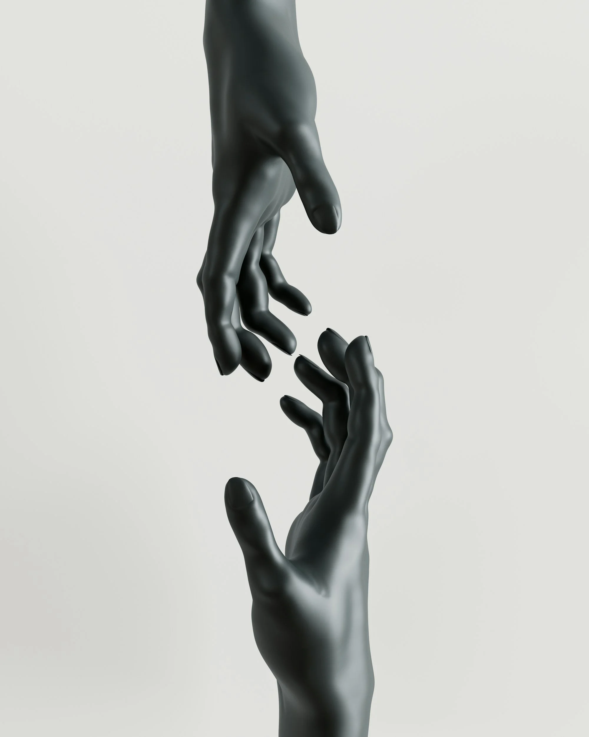 Two black mannequin hands reaching towards each other against a light background.