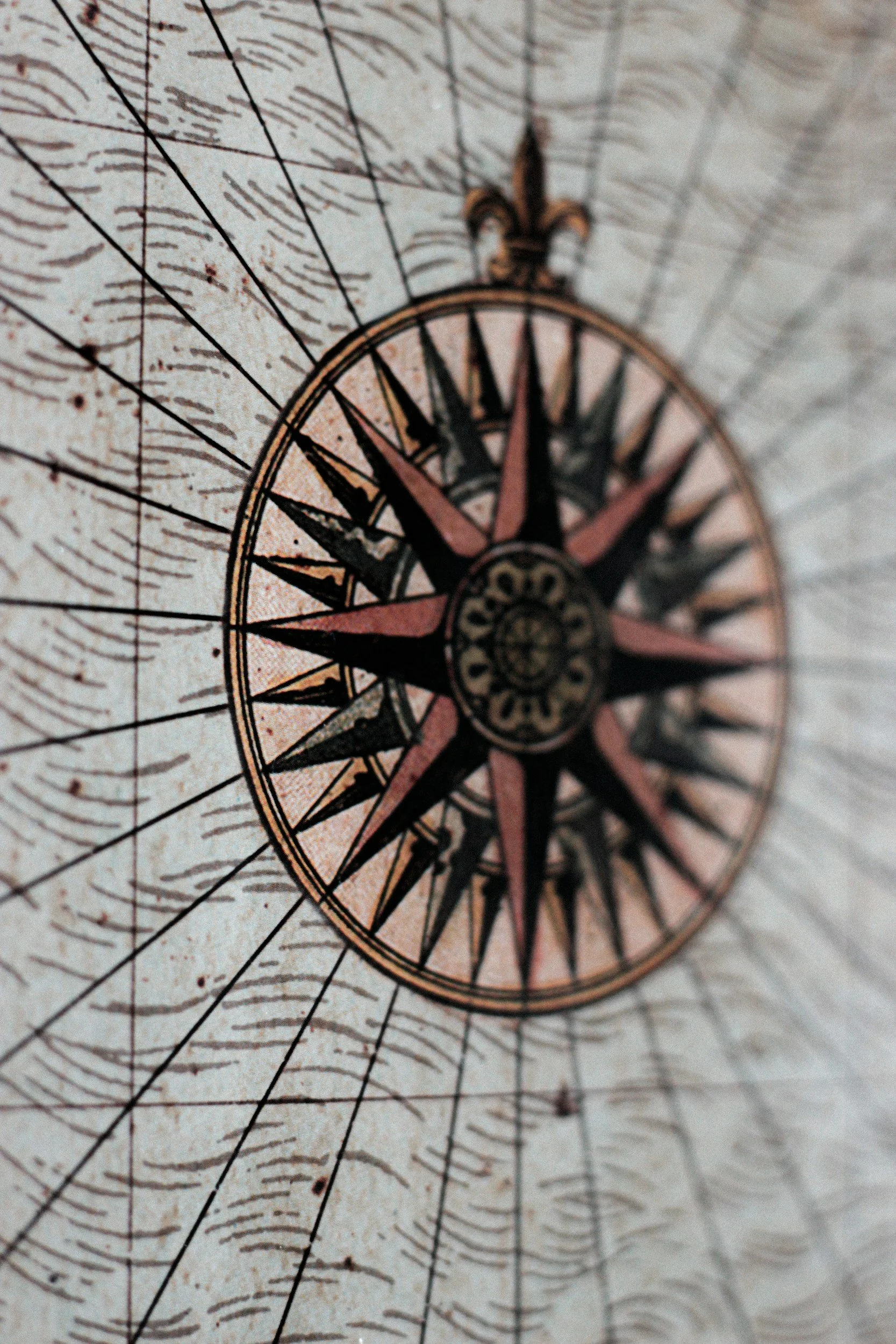 Vintage compass rose map for navigation with weathered surface and detailed markings.