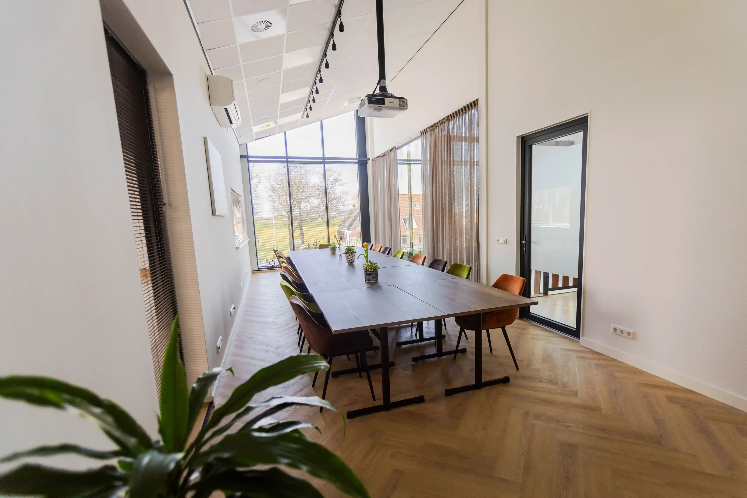 Vergaderruimte Lânsicht bij It Fjildhûs met lange vergadertafel en uitzicht over het Friese landschap.